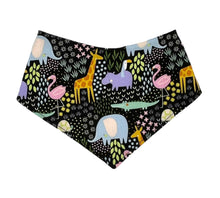 Load image into Gallery viewer, Baby bandana bib by Mimi's Little Loveys. Fun and vibrant design, featuring crocodiles, elephants, flamingos, giraffes, hippos, tortoises, plants, and flowers, on a black background. Backing is soft flannel.