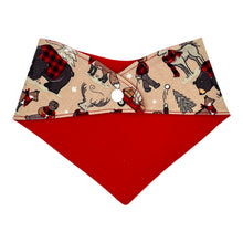 Load image into Gallery viewer, A baby bandana bib with a fabric winter plaid pattern featuring bears, beavers, deer, and foxes in a snowy setting. Reverse shown with red flannel backing.