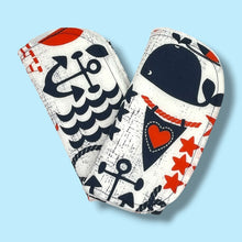 Load image into Gallery viewer, A pair of burpcloths, featuring a navy blue and red nautical design.