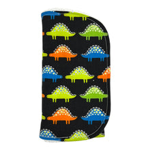 Load image into Gallery viewer, Folded burpcloth with colorful dinosaur pattern on a black background.