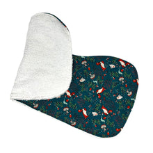 Load image into Gallery viewer, Folded burpcloth with foxes, rabbits, hedgehogs, and mushrooms, on a green background.