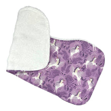 Load image into Gallery viewer, Folded burpcloth with unicorns pattern on a purple backing.