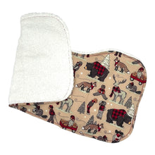 Load image into Gallery viewer, A burp cloth with a winter plaid pattern featuring bears, beavers, deer, and foxes in a snowy setting, and a terrycloth backing.