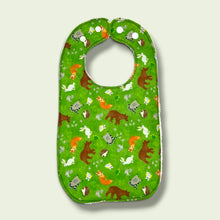 Load image into Gallery viewer, Baby bib, with bears, foxes, hedgehogs, owls, raccoons, squirrels, on a green background.