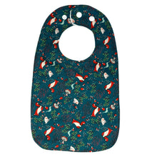 Load image into Gallery viewer, Baby bib with foxes, rabbits, and mushrooms, on a green background.
