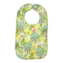 Load image into Gallery viewer, Baby Everyday bib by Mimi's Little Loveys. Features cute foxes, raccoons, squirrels in a forest scene. Shades of browns, oranges, grays, and greens, on a yellow background. Backing is white terry cloth.