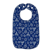 Load image into Gallery viewer, Navy blue baby bib with white Hanukkah menorahs, dreidels, and Stars of David, on a white background.