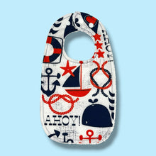 Load image into Gallery viewer, Baby bib with navy blue and red nautical and whales design.