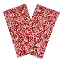 Load image into Gallery viewer, Red napkins with white Christmas-themed pattern.