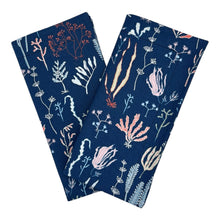 Load image into Gallery viewer, Two folded navy blue napkins with coral and sea life design.