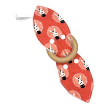 Load image into Gallery viewer, Teething ring with zebra pattern on a coral pink background. Teether is shown unsnapped.