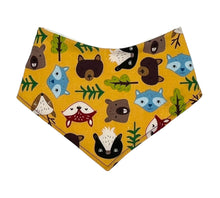 Load image into Gallery viewer, Baby bandana bib by Mimi&#39;s Little Loveys. Fun and vibrant design, featuring group of Maine friends - bear, beaver, deer, fox, raccoon, and skunk - on a mustard yellow background. Backing is soft flannel.
