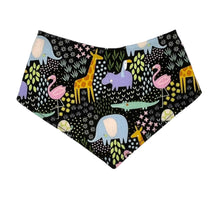 Load image into Gallery viewer, Baby bandana bib by Mimi&#39;s Little Loveys. Fun and vibrant design, featuring crocodiles, elephants, flamingos, giraffes, hippos, tortoises, plants, and flowers, on a black background. Backing is soft flannel.
