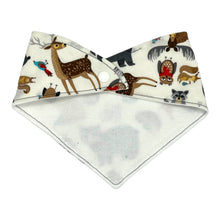 Load image into Gallery viewer, Baby bandana bib by Mimi&#39;s Little Loveys. Front features a collection of Maine critters: bears, cardinals, deer, moose, owls, porcupines, raccoons, squirrels, all on a white background. Backing is soft, white, flannel.
