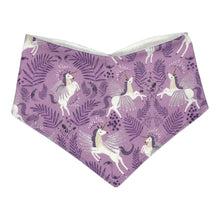 Load image into Gallery viewer, Baby bandana bib by Mimi's Little Loveys. White unicorns on a purple background. Leaf and flower details.
