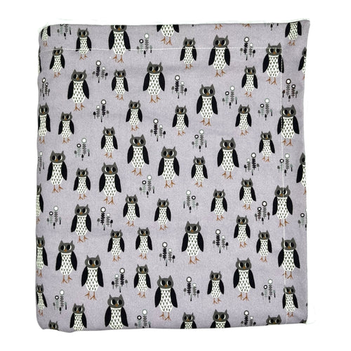 Baby and kids blanket with owl pattern on a light purple background.