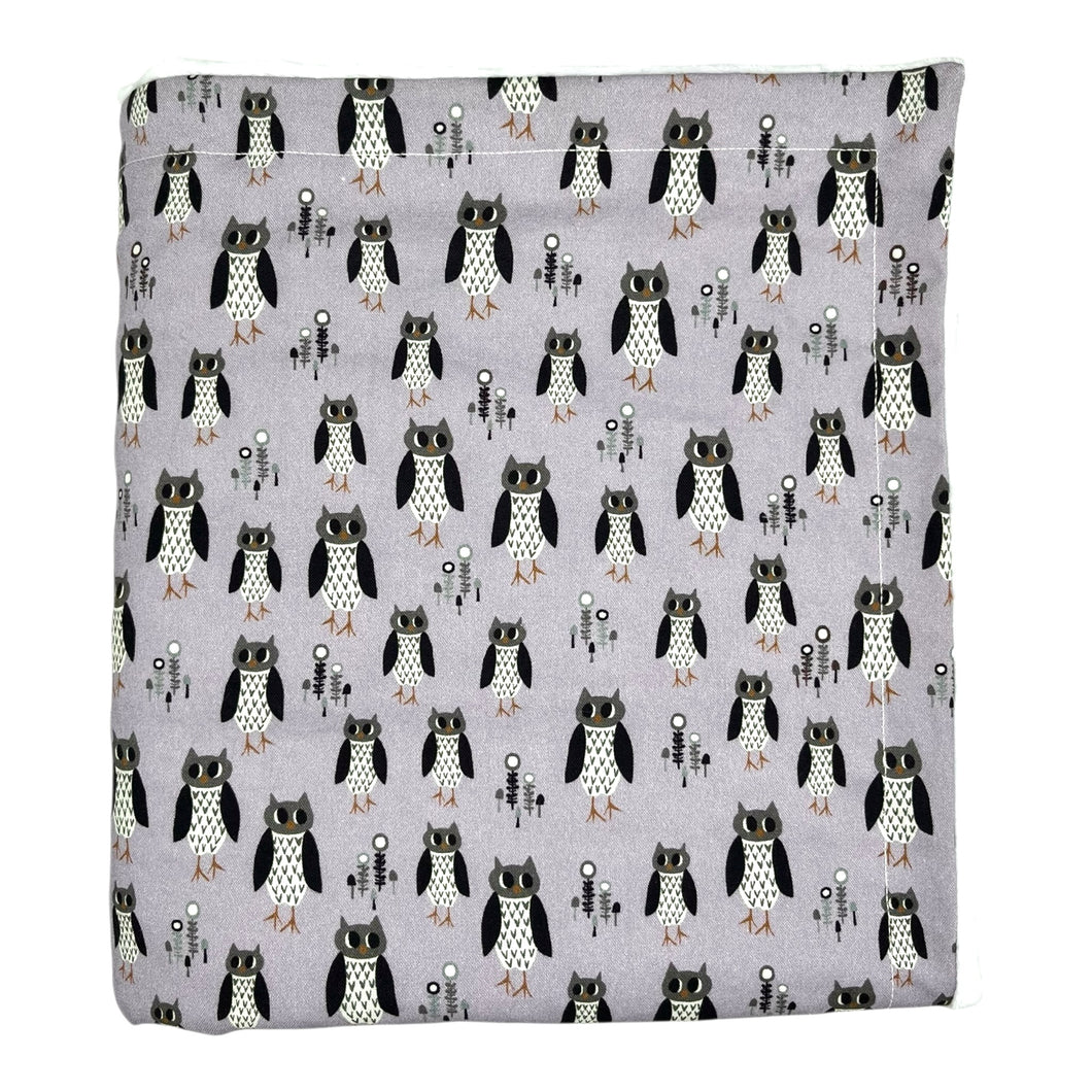 Baby and kids blanket with owl pattern on a light purple background.