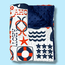 Load image into Gallery viewer, Folded blanket with blue and red nautical and whale design.
