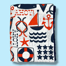 Load image into Gallery viewer, Folded blanket with blue and red nautical and whale design.
