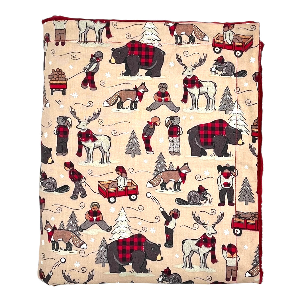 Baby and kids' blanket with bears, beavers, foxes, deer, and kids wearing buffalo plaid in winter.