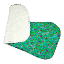 Load image into Gallery viewer, Folded burpcloth with purple, pink and red flowers on a green background.
