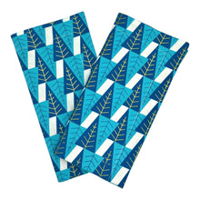 Load image into Gallery viewer, Pair of cotton dinner napkins with contemporary blue and gold winter trees.
