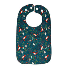 Load image into Gallery viewer, Baby bib with foxes, rabbits, and mushrooms, on a green background.
