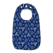 Load image into Gallery viewer, Navy blue baby bib with white Hanukkah menorahs, dreidels, and Stars of David, on a white background.
