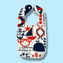 Load image into Gallery viewer, Baby bib with navy blue and red nautical and whales design.
