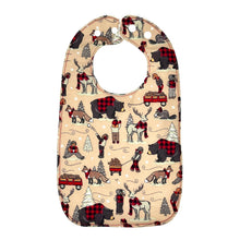 Load image into Gallery viewer, A baby bib with a fabric winter plaid pattern featuring bears, beavers, deer, and foxes in a snowy setting. 
