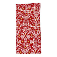 Load image into Gallery viewer, Red napkin with white Christmas-themed pattern.
