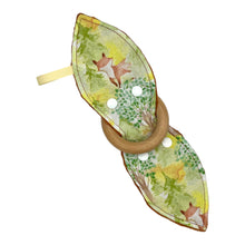 Load image into Gallery viewer, Baby Crinkle Teether by Mimi's Little Loveys. Features cute foxes, raccoons, squirrels in a forest scene. Shades of browns, oranges, grays, and greens, on a yellow background, and a wooden teething ring.
