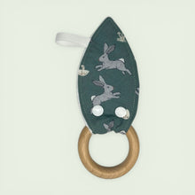 Load image into Gallery viewer, Teething ring with wooden ring and green fabric cover featuring rabbit designs
