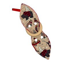 Load image into Gallery viewer, A teether with a fabric winter plaid pattern featuring bears, beavers, deer, and foxes in a snowy setting. Wooden teething ring.
