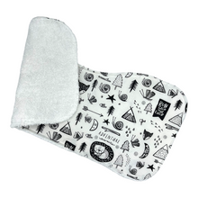 Load image into Gallery viewer, Folded burpcloth with black and white nature patterns.
