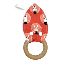 Load image into Gallery viewer, Teething ring with zebra pattern on a coral pink background.
